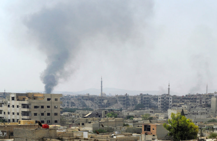 التلفزيون السوري: معارضون مسلحون أحرقوا بنايات في داريا قبل مغادرتها