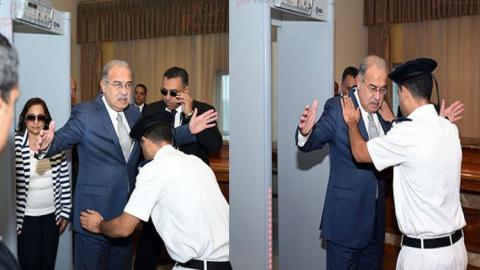 شرطي يفتش رئيس الوزراء المصري